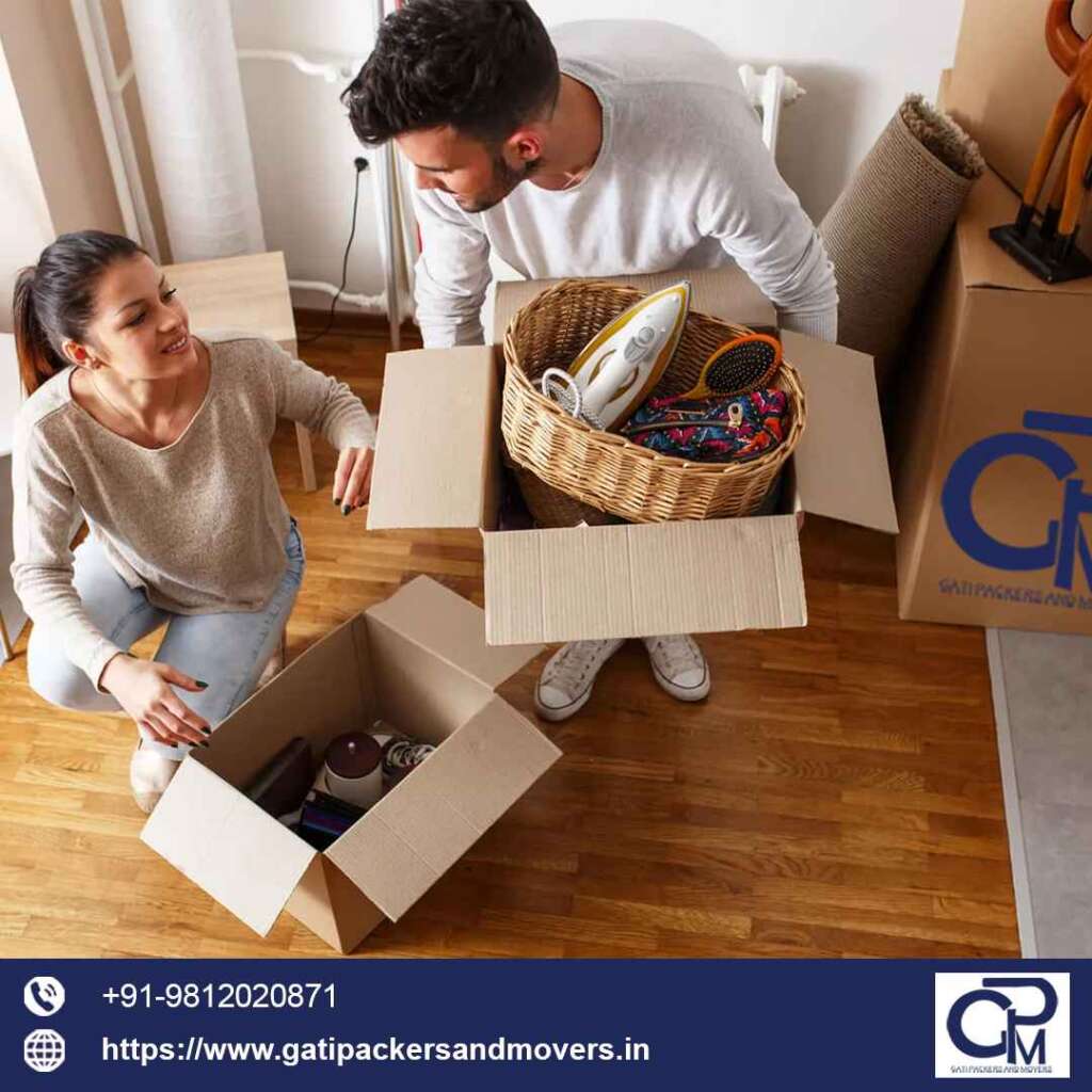 one female and one male shifting packing their household goods in gati packers and movers bangalore boxes